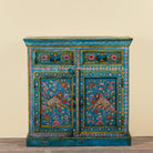 Rajat hand-painted blue reclaimed wood cabinet with colourful floral and animal motifs, two drawers and two doors.