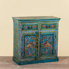 Side angle image of a Rajat hand-painted blue reclaimed wood cabinet with colourful floral and animal motifs, two drawers and two doors.