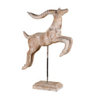 White background image of a handcrafted wooden deer sculpture Rajul on an iron stand with a whitewashed finish. A vintage home accessory and unique Indian decoration ideal for vintage home decor on consoles or shelves.