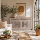 Lifestyle image of a Rajula handcrafted solid mango wood sideboard with hand-carved floral doors, whitewashed finish, four spacious storage compartments, and traditional Indian craftsmanship, 180cm.