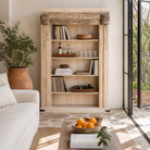 Lifestyle image of a hand-carved shelf made from reclaimed teak wood and mango wood, unique furniture with Ibiza-inspired finish, 150 × 208 × 52 cm.