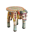 Side angle image of a hand-painted wooden Ram side table in the shape of a ram with curved horns, featuring colourful Indian folk art patterns, ideal for vintage and India-inspired home accessories.