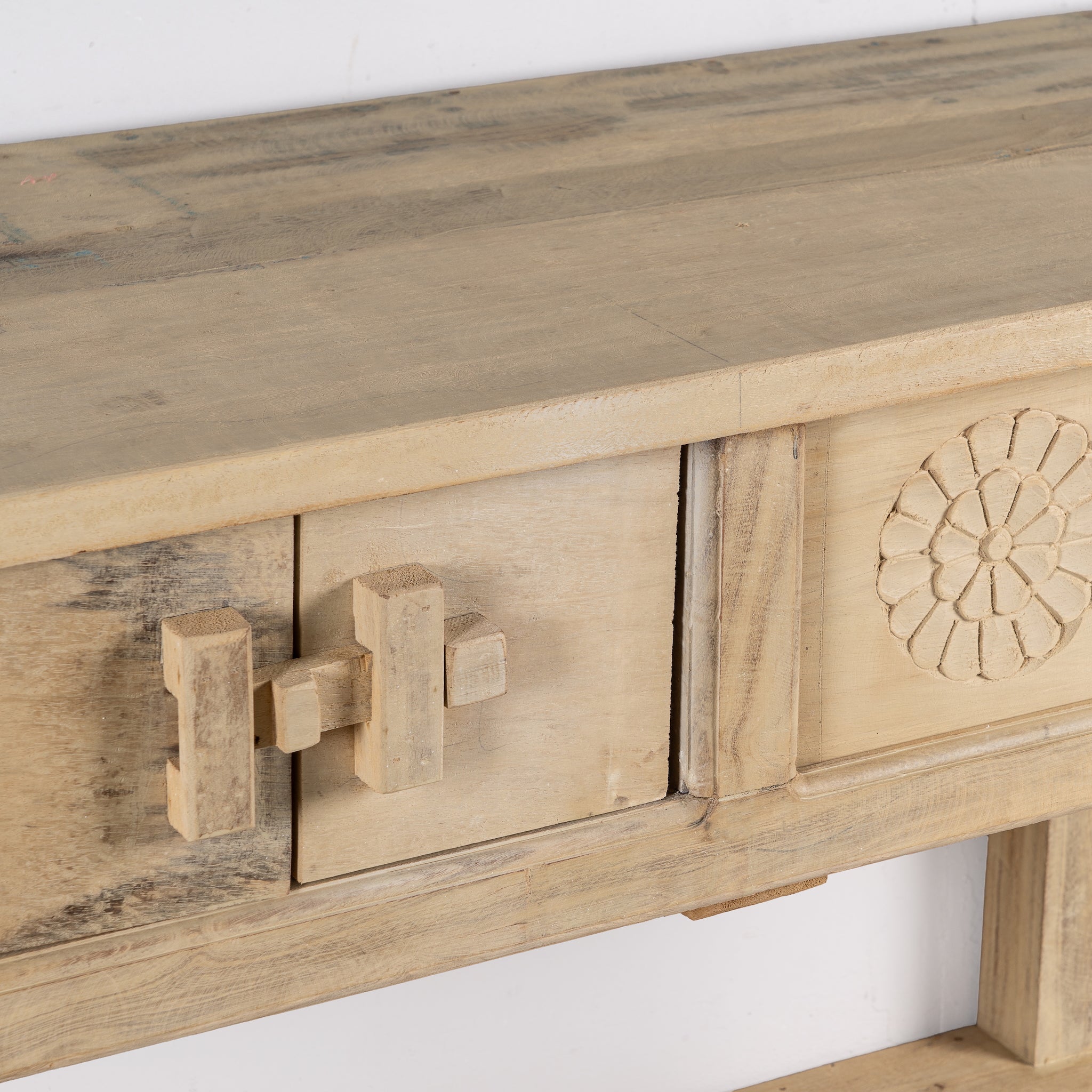 Close up image of a rustic reclaimed teak console table with hand-carved detailing and hidden side compartments; sustainable furniture, 170 × 82 × 48 cm.
