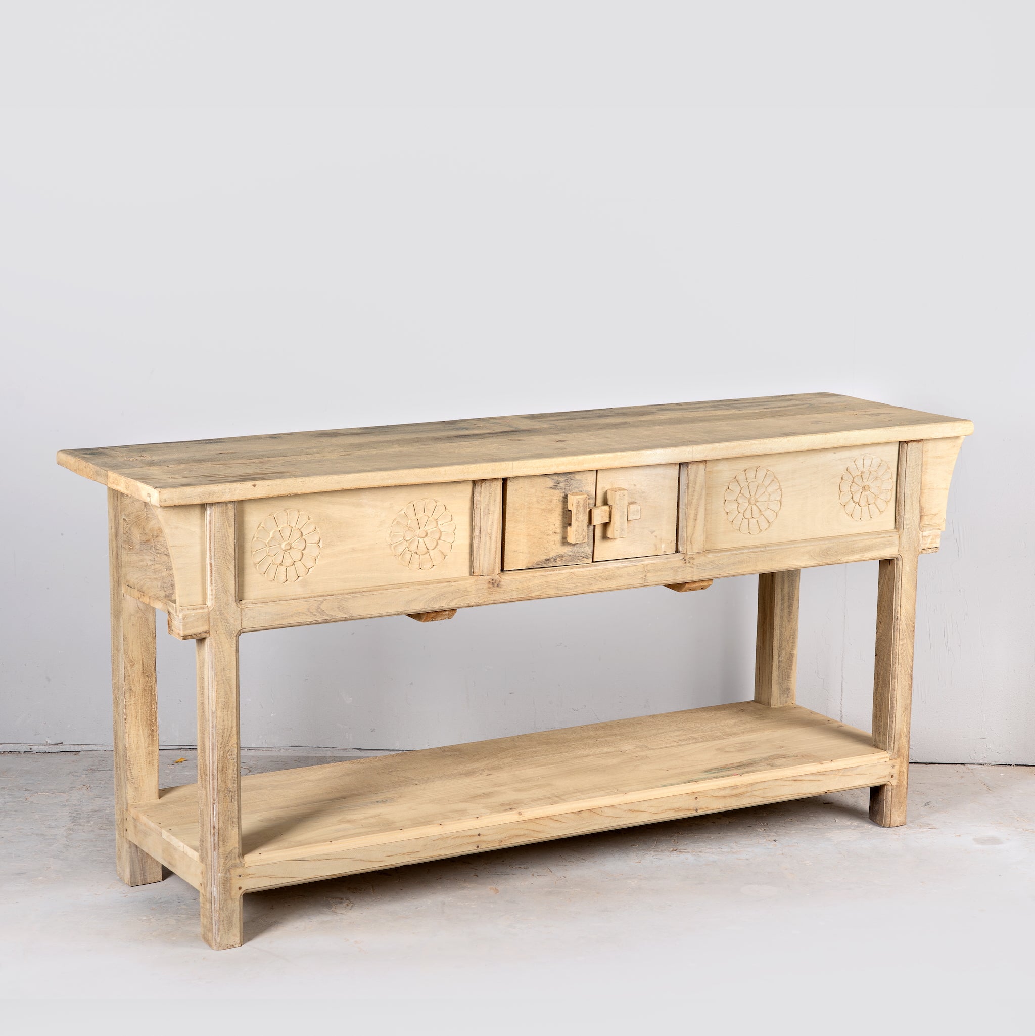 Side angle image of a rustic reclaimed teak console table with hand-carved detailing and hidden side compartments; sustainable furniture, 170 × 82 × 48 cm.
