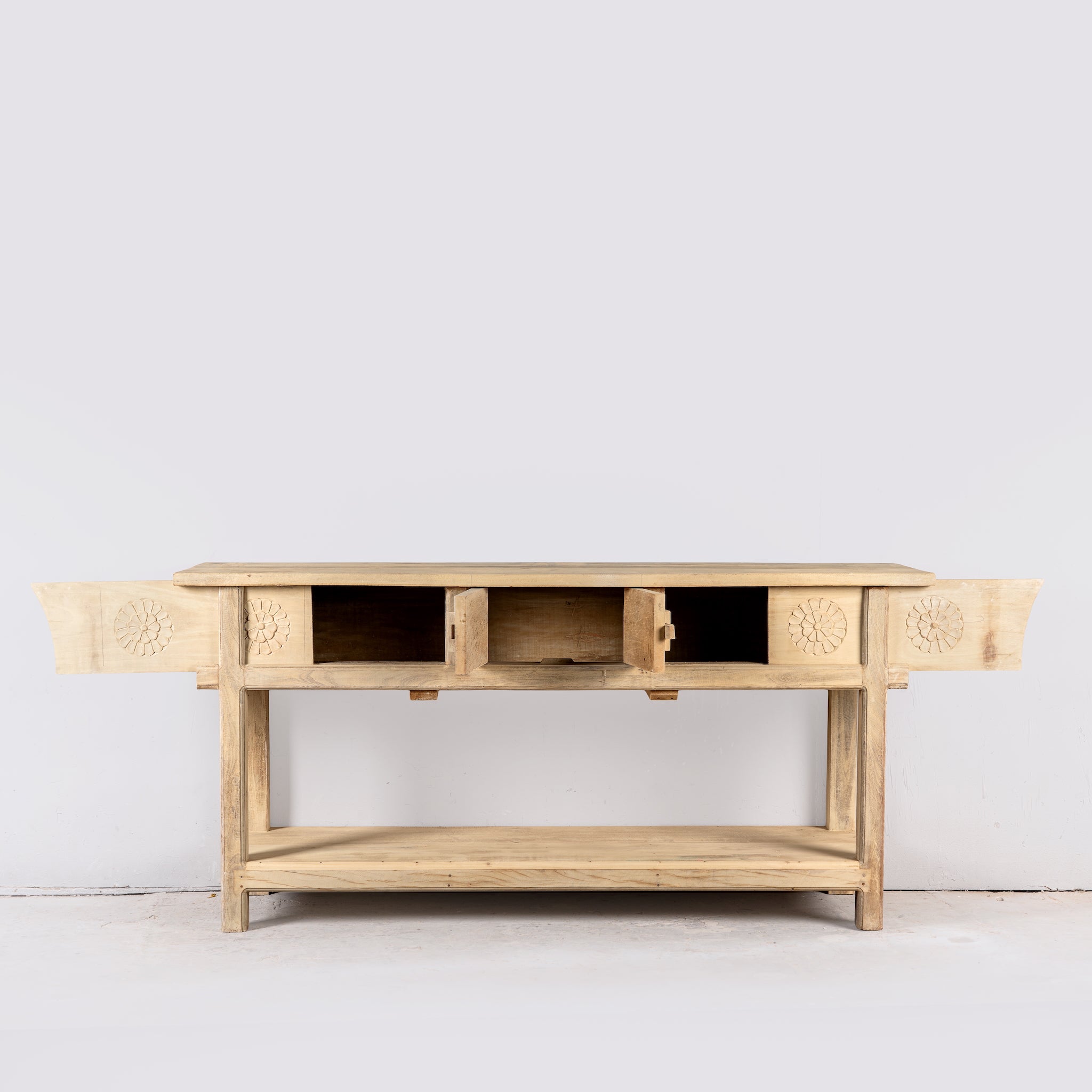 Image of a rustic reclaimed teak console table with hand-carved detailing and hidden side compartments; sustainable furniture, 170 × 82 × 48 cm.
