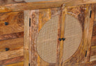 Close up image of a hand-carved wood furniture sideboard with floral motifs and rattan cabinet doors, solid mango wood rattan furniture, 160 × 40 × 90 cm.