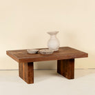Rectangular reclaimed wood coffee table with block legs; sustainable furniture for rustic and modern interiors, 120 × 80 × 46 cm.