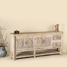 Side angle image of a vintage console table made from reclaimed wood with carved teak front, two drawers, four cupboards, and lower shelf, 201 × 42 × 100 cm.