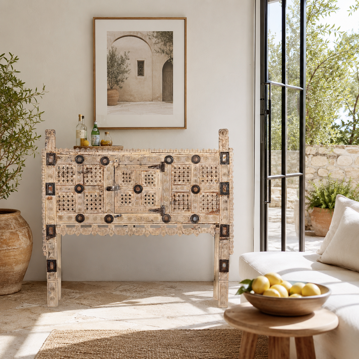 Lifestyle image of a sandblasted antique Indian teak chest with hand-carved details, original iron fittings, and a naturally aged finish, ideal for bohemian or vintage-inspired interiors.