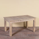 Side angle image of a Ravi bleached reclaimed wood dining table with rectangular top and straight wooden legs, 150x90x76cm