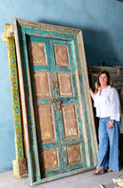 Hand-carved old Indian teak door with frame and original door handles in vintage style.