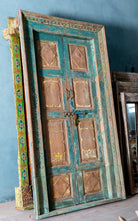 Antique Indian teak wood door with turquoise patina, golden accents, and brass hardware, vintage wall panels and vintage home decor.