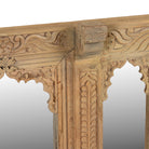 Close up image of a Rishab hand carved reclaimed teak wood mirror made from an original Indian window frame with three arched mirror panels 122cm