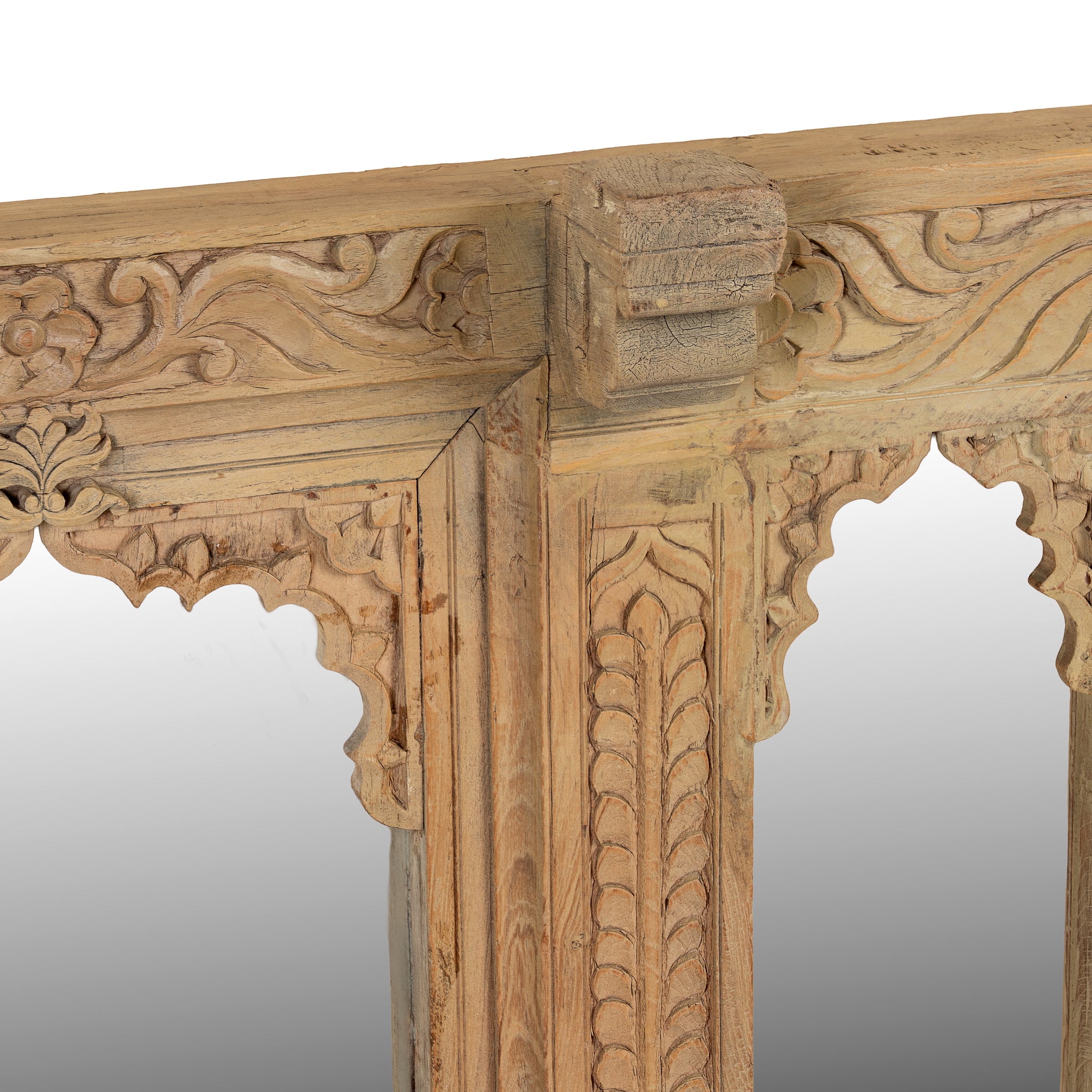 Close up image of a Rishab hand carved reclaimed teak wood mirror made from an original Indian window frame with three arched mirror panels 122cm