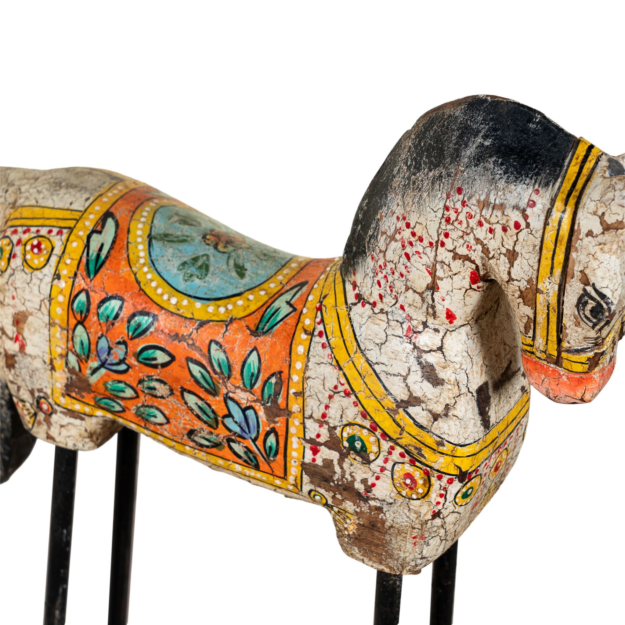 Hand-painted wooden horse sculptures on iron stands in assorted colours and designs. Unique Indian decor items, perfect for bohemian interiors and artisanal furniture displays.