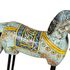 Close up image of a Hand-painted wooden horse sculptures on iron stands in assorted colours and designs. Unique Indian decor items, perfect for bohemian interiors and artisanal furniture displays.