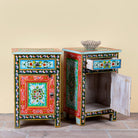 Side angle image with open drawer and door of a hand-painted bedside table made from recycled wood – vintage night stands with carved mango wood furniture detailing and floral artistry.