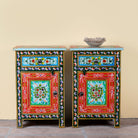 Image of a pair of hand-painted bedside tables made from recycled wood – vintage night stands with carved mango wood furniture detailing and floral artistry.