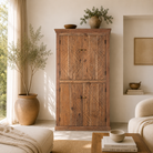 Carved Wooden cabinet in a living room with plants and books