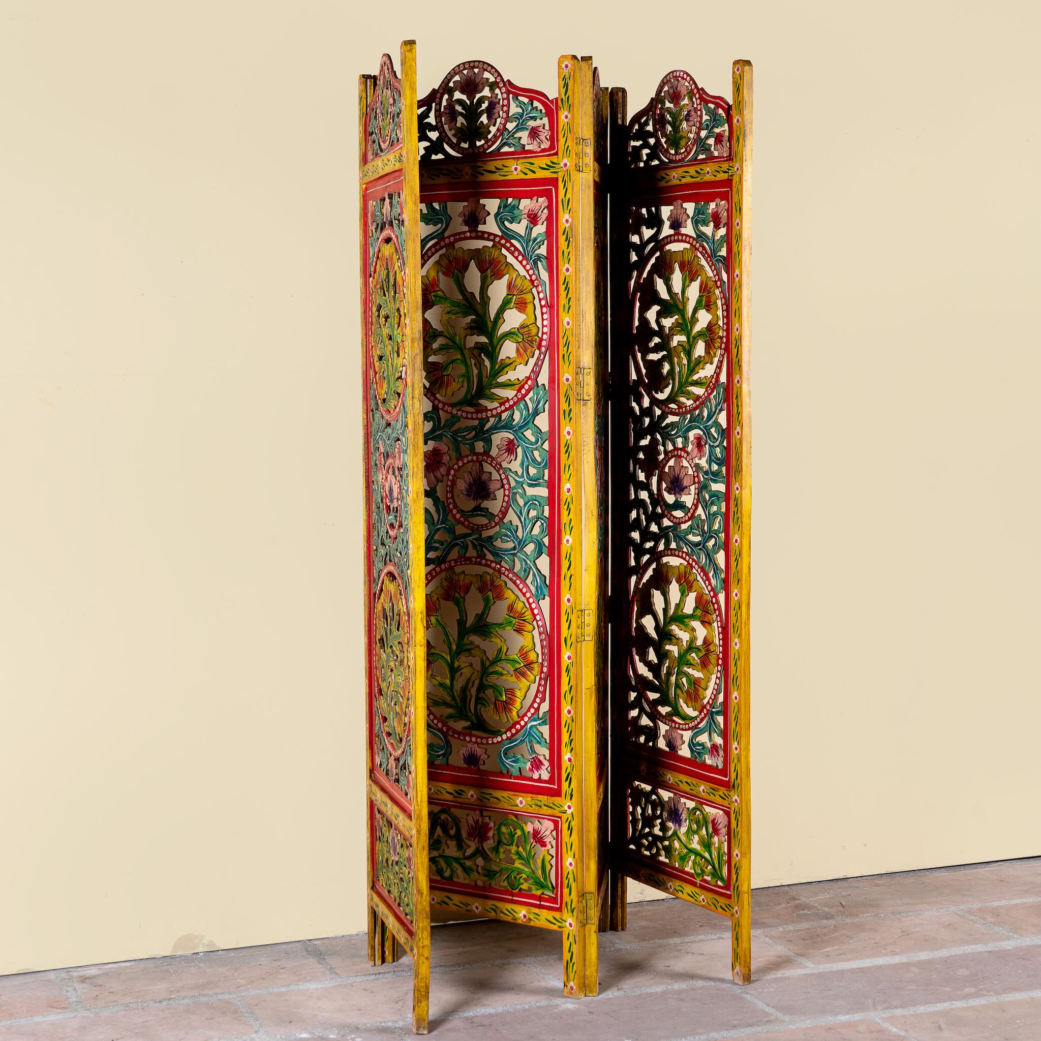 Hand carved and hand painted mango wood room divider with colourful floral Indian motifs and folding panels.