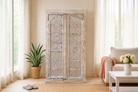 Lifestyle image of a handcrafted carved wood wardrobe with whitewashed finish and arched teak doors – Ruchi by Om Home & Garden, vintage-inspired white washed furniture with artisanal detailing.