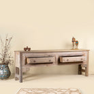Open drawer image of a teak wood console table with two drawers, carved leg details, and sanded reclaimed finish, 223 × 45 × 83 cm.