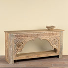 Side angle image of a Ruhan reclaimed teak wood console table with hand-carved Indian architectural front and open storage shelf 171cm
