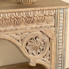 Close up image of a Ruhan reclaimed teak wood console table with hand-carved Indian architectural front and open storage shelf 171cm