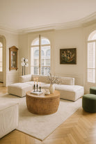 Lifestyle image of a hand-carved mango wood coffee table with intricate botanical and geometric carvings.