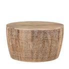 White background image of a hand-carved mango wood coffee table with intricate botanical and geometric carvings.