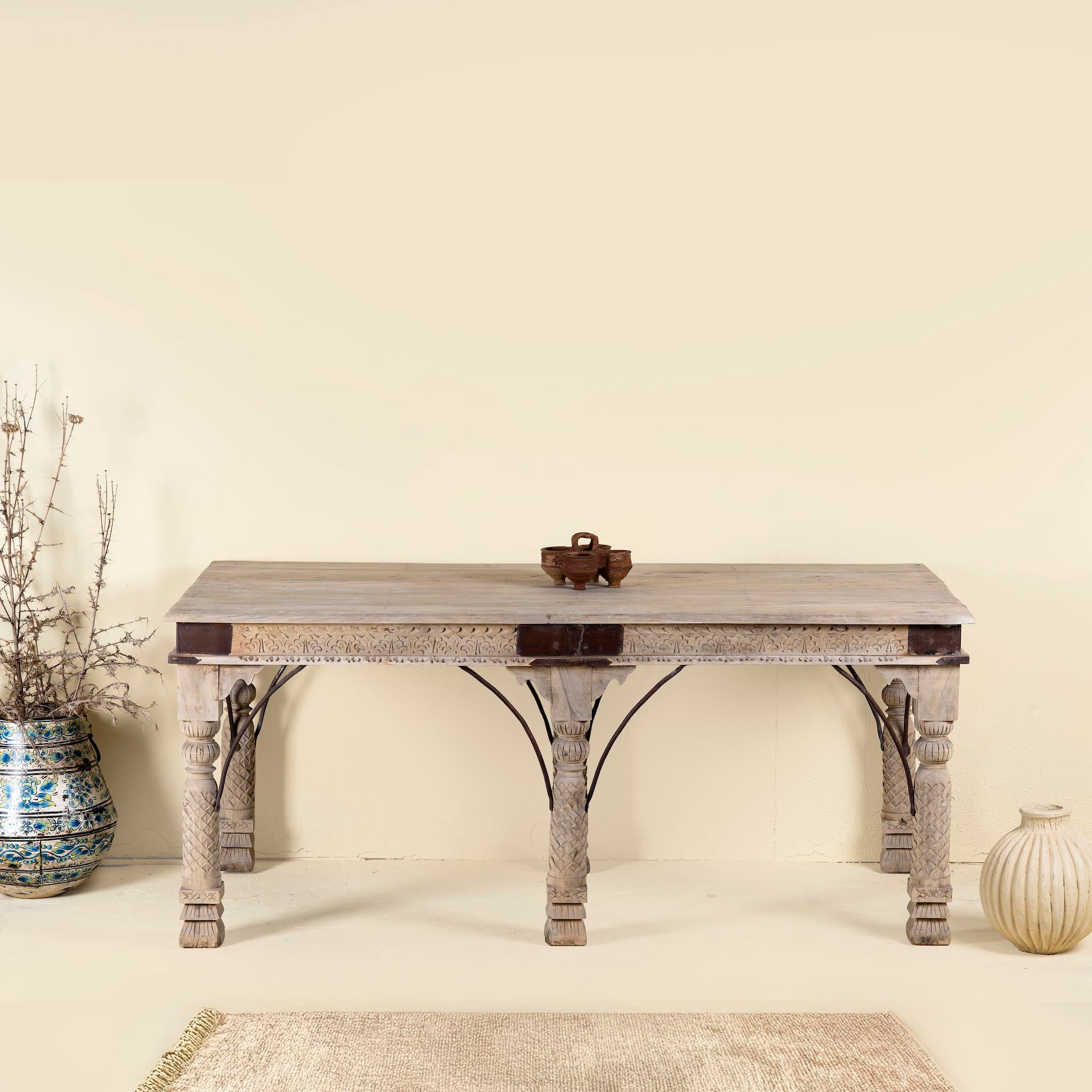 Teak wood dining table with six hand-carved pillar legs; reclaimed Indian dining table, 180 × 90 × 75 cm.