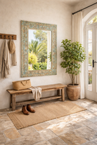 Lifestyle imagination of a Carved mango wood mirror Anuvinda with turquoise finish and hand-carved detailing. A vibrant vintage home decor piece reflecting traditional Indian craftsmanship.