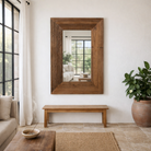 Lifestyle image of a hand made reclaimed wood mirror in rustic design.