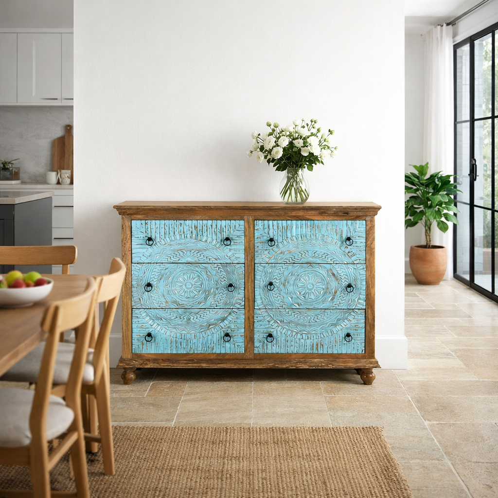 Lifestyle imagination of a hand-carved mango wood chest of drawers Safita with distressed blue finish and iron fittings, boho style living room furniture, 140 × 42 × 100 cm.