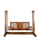 Wite background image of a Rutvi mango wood swing bench with stand, rattan backrests and folding coffee table, 237cm