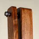Close up image of a Rutvi mango wood swing bench with stand, rattan backrests and folding coffee table, 237cm