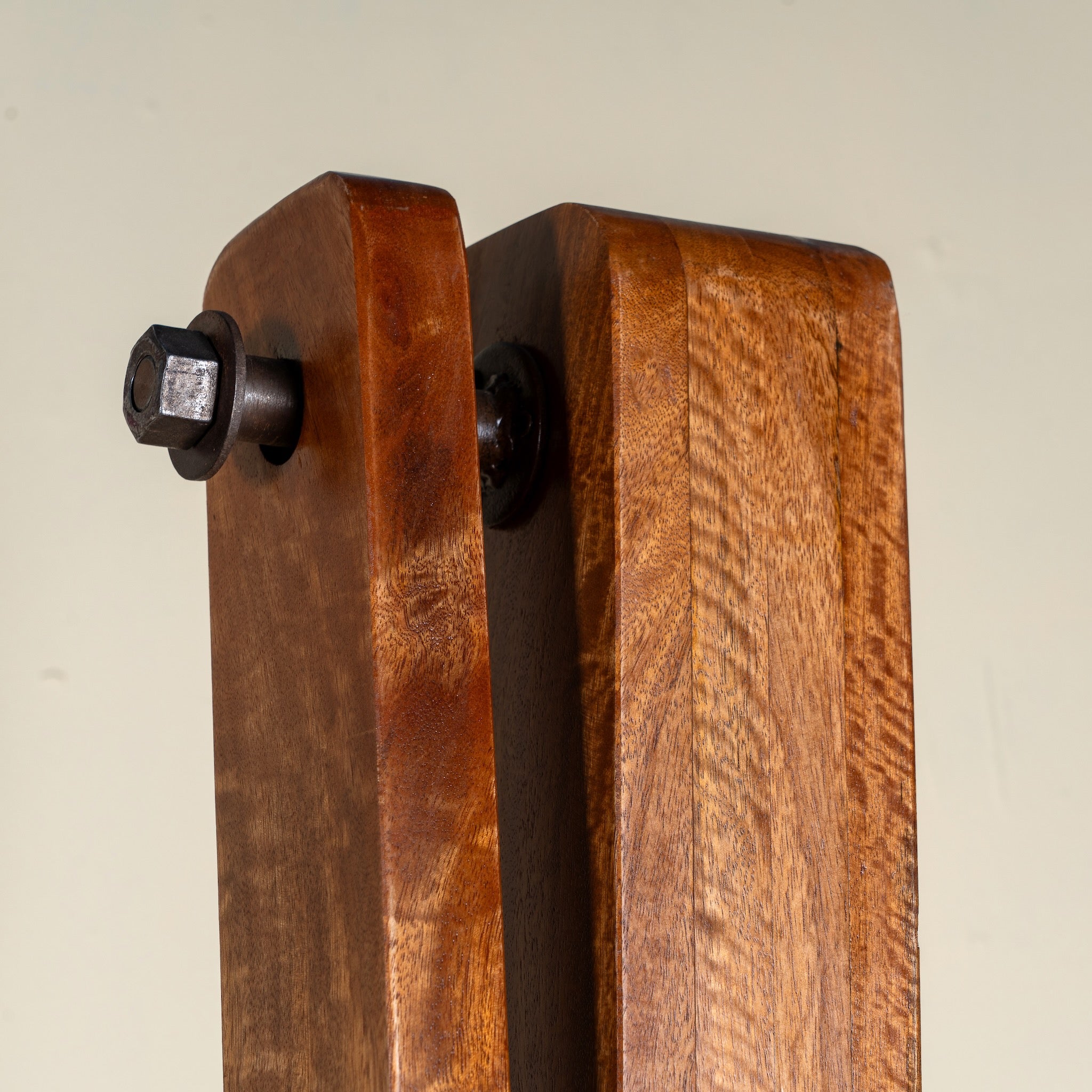 Close up image of a Rutvi mango wood swing bench with stand, rattan backrests and folding coffee table, 237cm