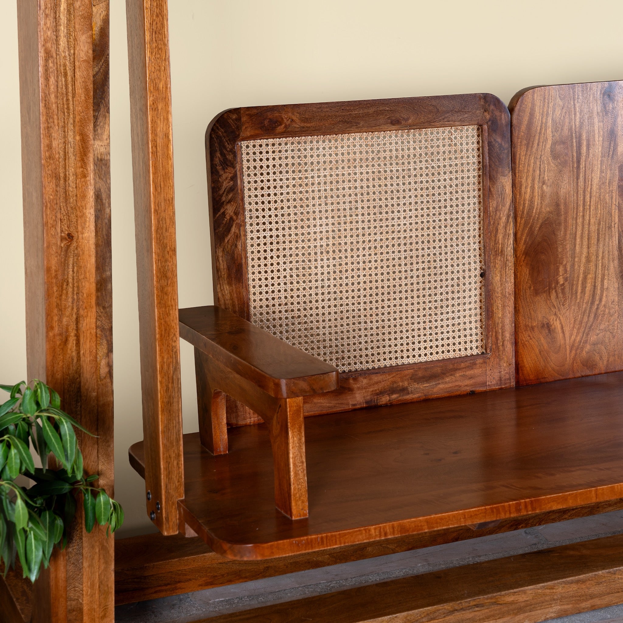 Close up image of the seat of a Rutvi mango wood swing bench with stand, rattan backrests and folding coffee table, 237cm