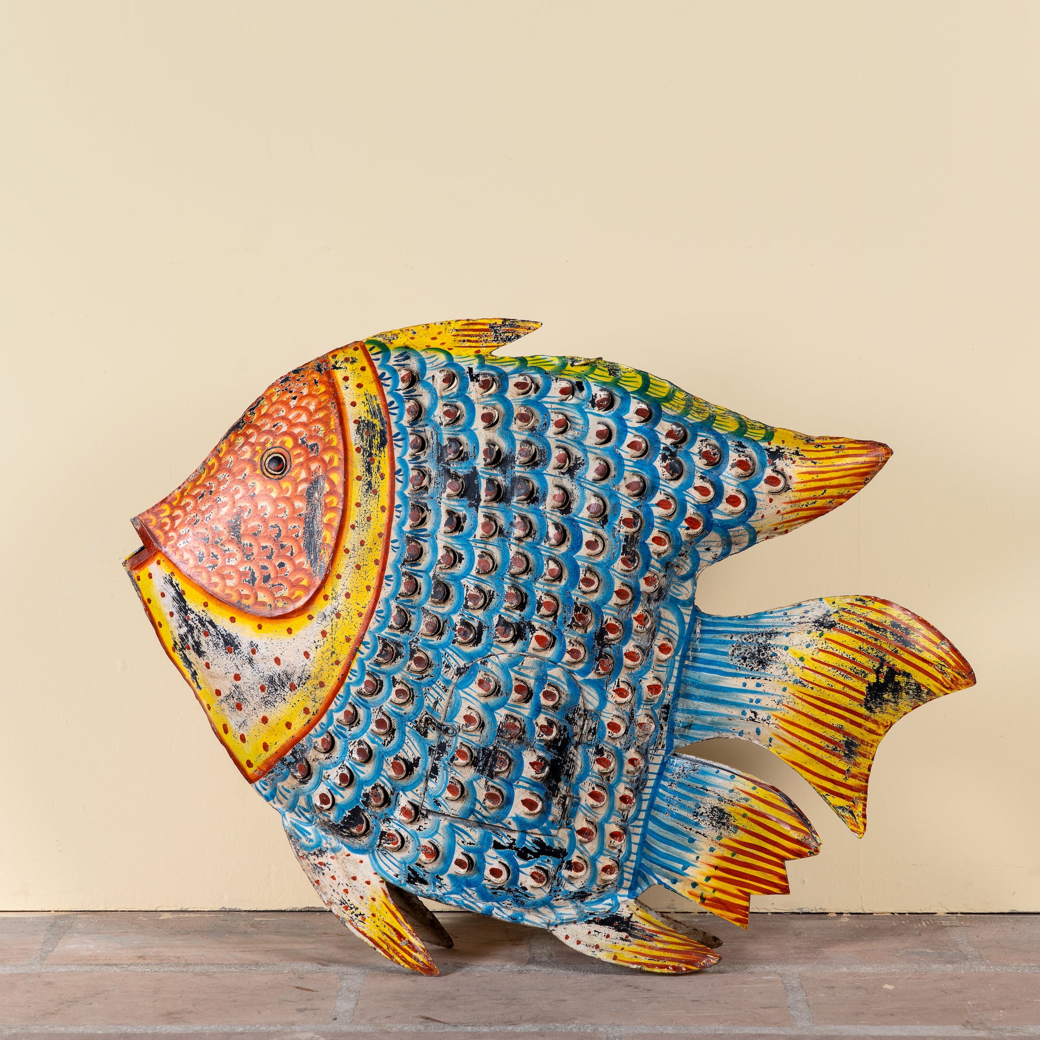 Saatvik hand painted freestanding metal fish sculpture with vibrant blue, orange and yellow detailing, handcrafted decorative home accessory, 107x15x80cm.
