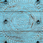 Close up image of a hand-carved mango wood chest of drawers Safita with distressed blue finish and iron fittings, boho style living room furniture, 140 × 42 × 100 cm.
