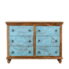 White background image of a hand-carved mango wood chest of drawers Safita with distressed blue finish and iron fittings, boho style living room furniture, 140 × 42 × 100 cm.