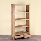 Side angle image of a Sahadev wide mango wood shelving unit with open shelves and two drawers 190cm