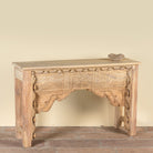 Side angle image of a Saiyan reclaimed teak wood console table with hand-carved old Indian house elements and architectural front 140cm