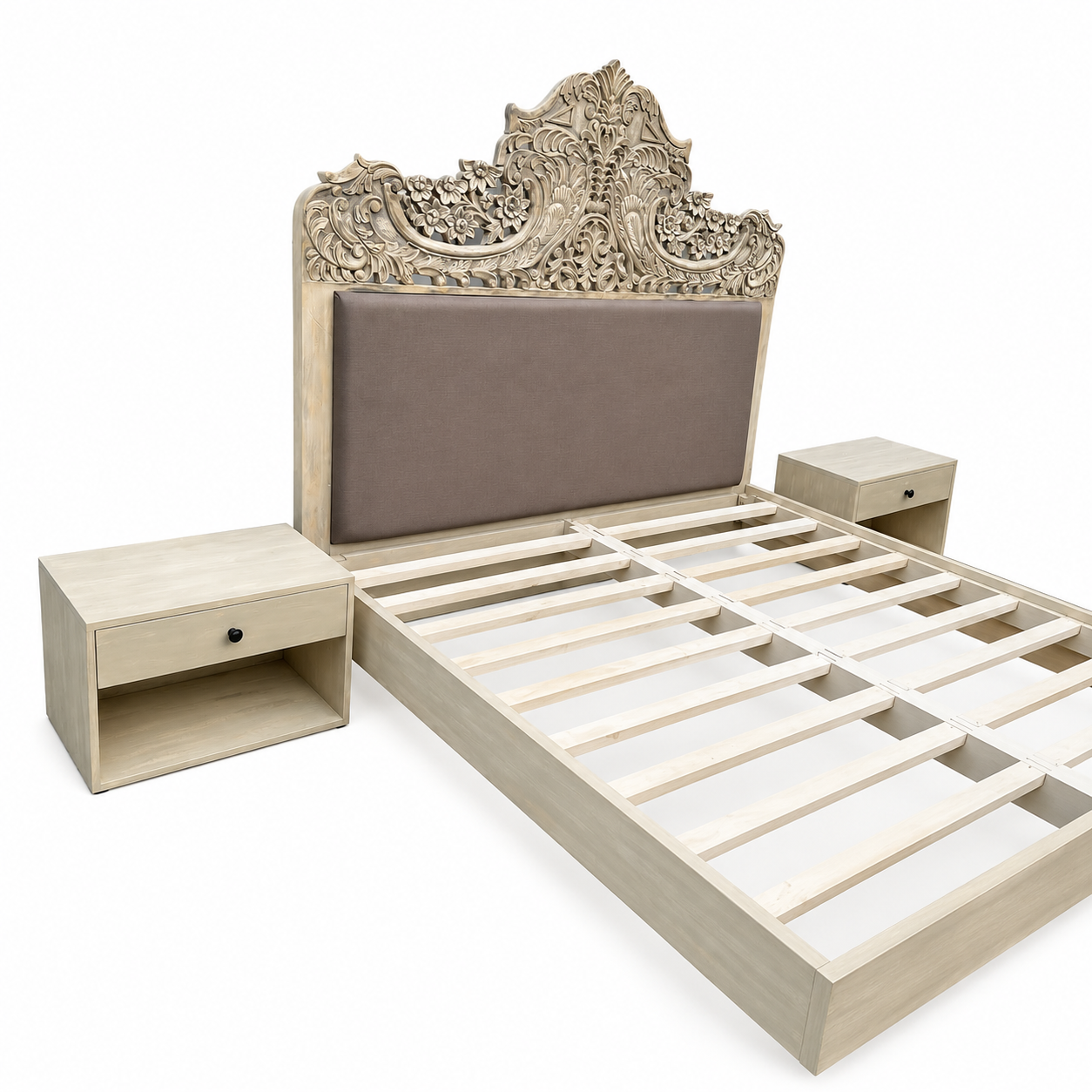 Side angle image of a hand-carved vintage bed Samar made from distressed mango wood, featuring an ornate high headboard with soft grey fabric upholstery. A unique blend of Indian craftsmanship and contemporary comfort in a natural, neutral palette.