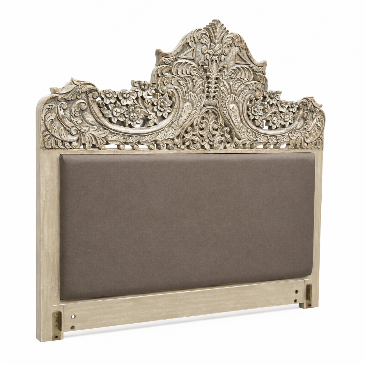 Close up image of a hand-carved vintage bed Samar made from distressed mango wood, featuring an ornate high headboard with soft grey fabric upholstery. A unique blend of Indian craftsmanship and contemporary comfort in a natural, neutral palette.