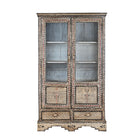 White background image of a hand-painted display cabinet made from recycled wood with glass doors – sustainable furniture featuring Sanskrit motifs and traditional Indian craftsmanship.