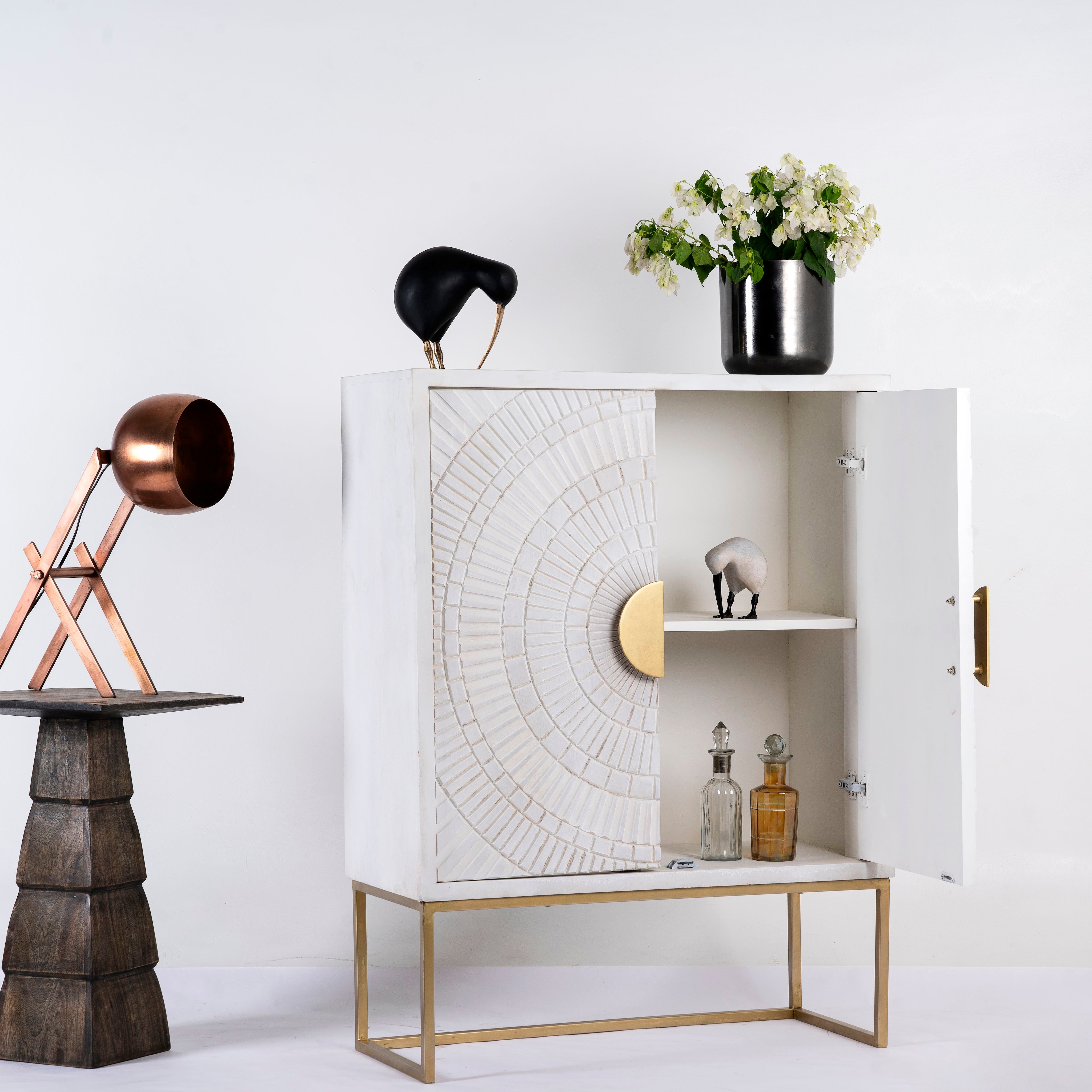 Open door image of a whitewashed mango wood buffet with carved lines and antique brass iron base, 90 × 120 × 42 cm.