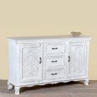 Side angle image of a mediterranean-style carved sideboard in solid mango wood with floral motifs and elegant legs; ideal for vintage home decor, 150 × 90 × 40 cm.