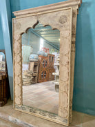 Reclaimed teak mirror Satish with minimalist arch shape and subtle floral carvings. A tall boho wall decor piece ideal for Mediterranean and contemporary interiors.