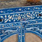 Close up image of a Satya hand painted reclaimed wood cabinet with natural rattan doors 105cm